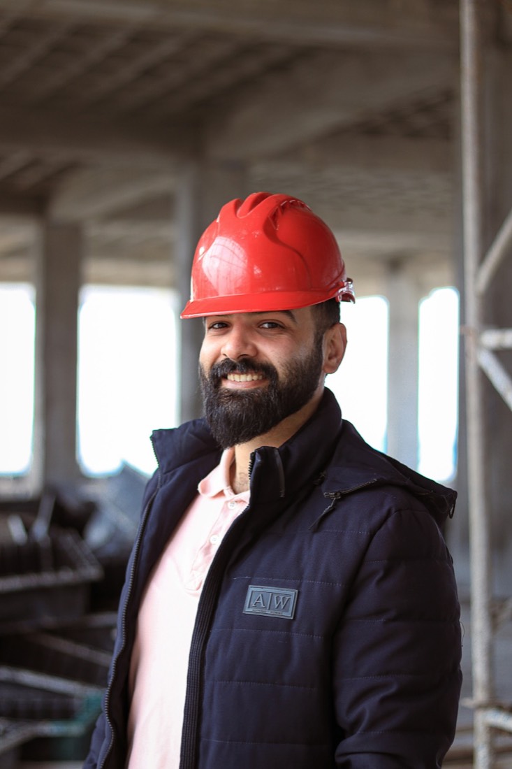 Service professional wearing a red safety helmet