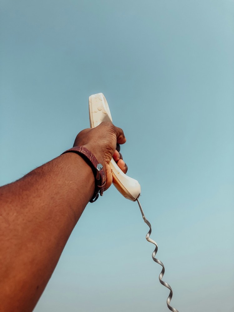 Hand holding a telephone receiver
